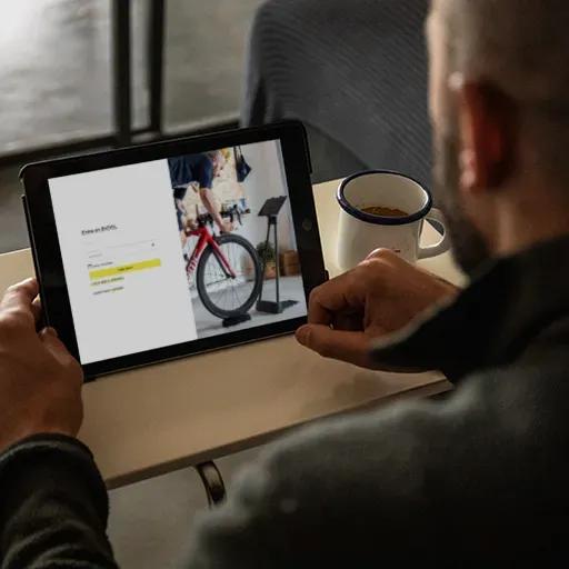 Man registering as a user of the BKOOL cycle simulator on his computer.