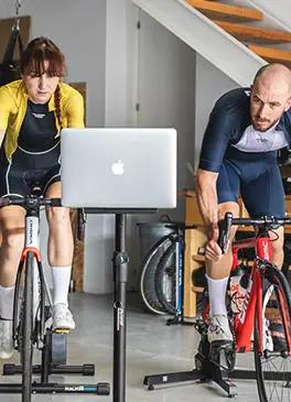 Cyclists training at home with an indoor cycling simulator